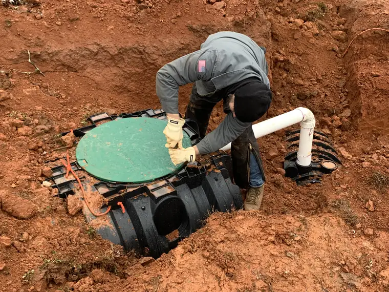 SepticRooter™ technician servicing a septic pump riser in Grayson, Gwinnett County