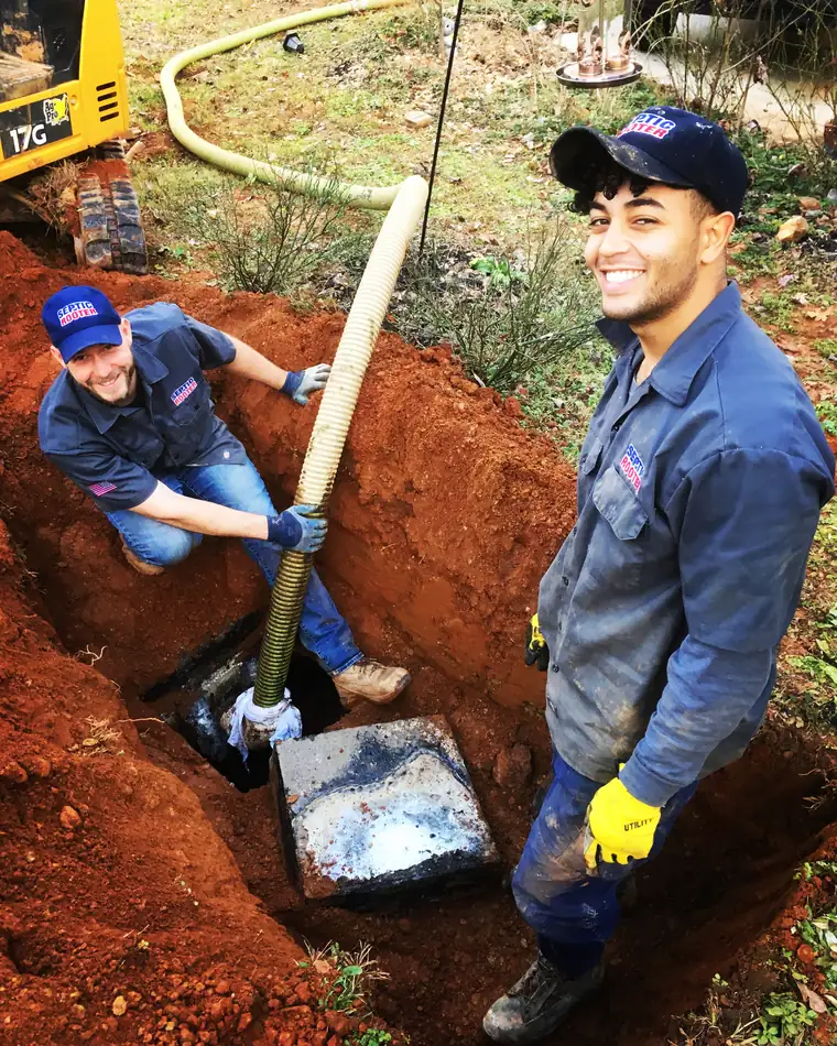 SepticRooter™ licensed technicians repairing a septic system in Grayson, Gwinnett County