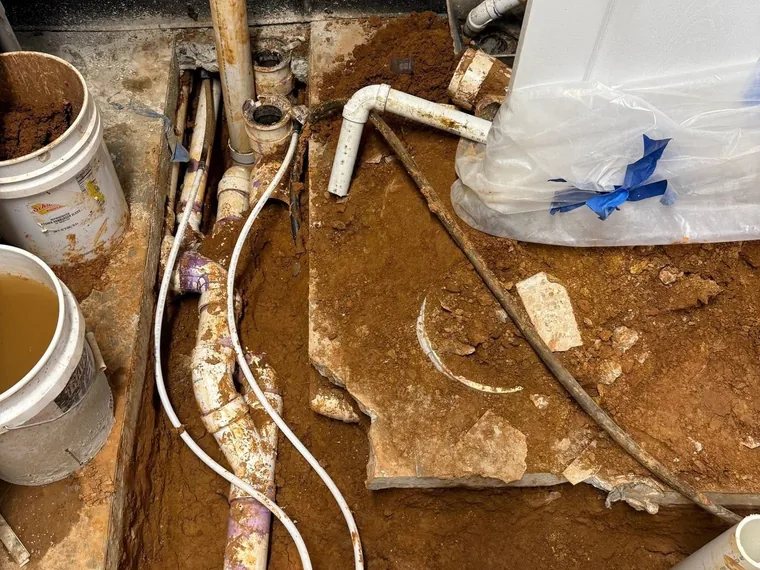 Rerouted under-slab PVC drain lines for a commercial kitchen grease trap