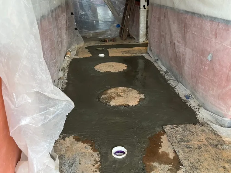 Finished concrete floor with grease interceptor access lids set flush