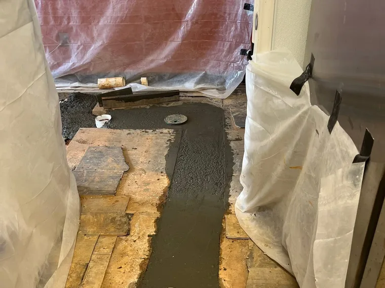Concrete trench patch with a flush cleanout in a restaurant back-of-house
