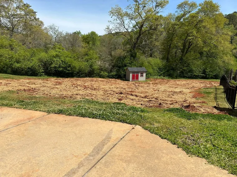 Finished drain field seeded and strawed after replacement at a McDonough, Georgia residential property