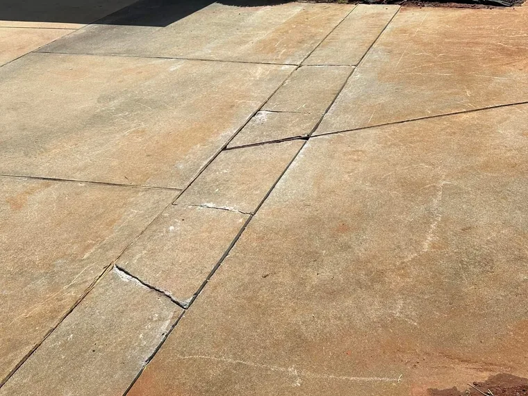 Concrete driveway cut seams after repair and re-seaming over a replaced drain field in McDonough